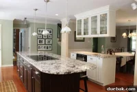 Elegant Classic Kitchen: Granite Island and Luminous White Glass Cabinetry
