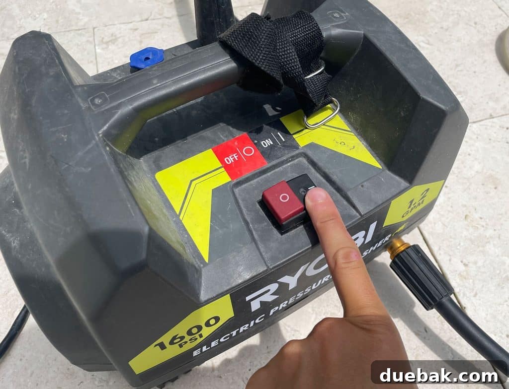 Essential Pressure Washer Tips For First Timers 12 Pressing power button on Ryobi electric pressure washer