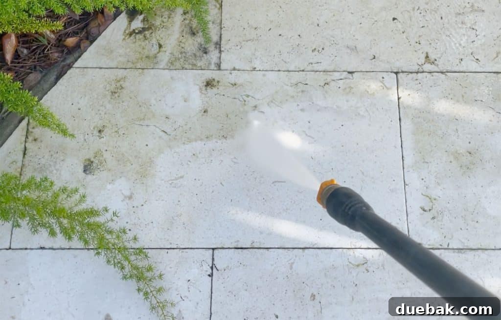 Essential Pressure Washer Tips For First Timers 22 Spraying Pool Patio Stone With Electric Pressure Washer To Remove Scum