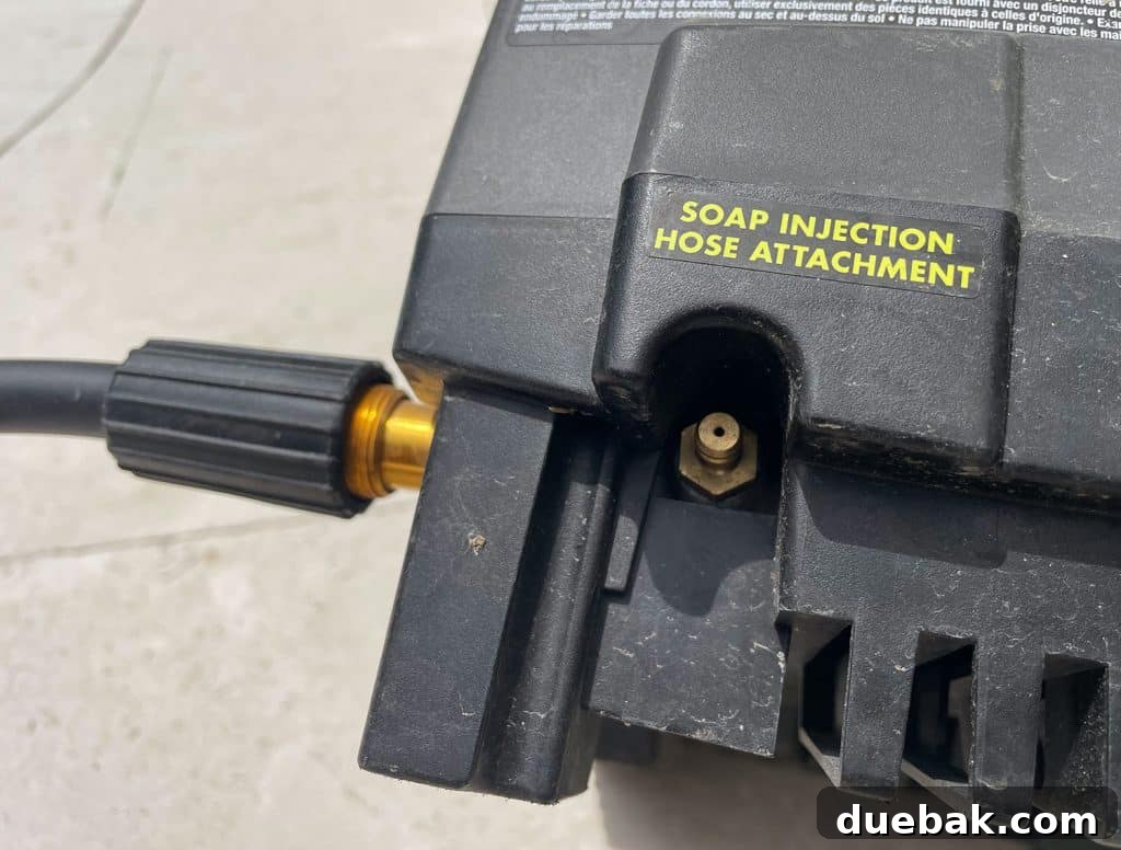 Essential Pressure Washer Tips For First Timers 24 Soap Injection Hose Attachment nozzle on side of Ryobi Electric Pressure Washer