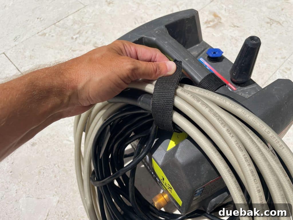 Essential Pressure Washer Tips For First Timers 25 Securing cords on Ryobi electric pressure washer with built in velcro strap