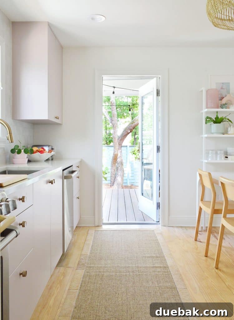 Open door view to the kitchen porch with lush trees outside, showcasing the seamless indoor-outdoor connection.