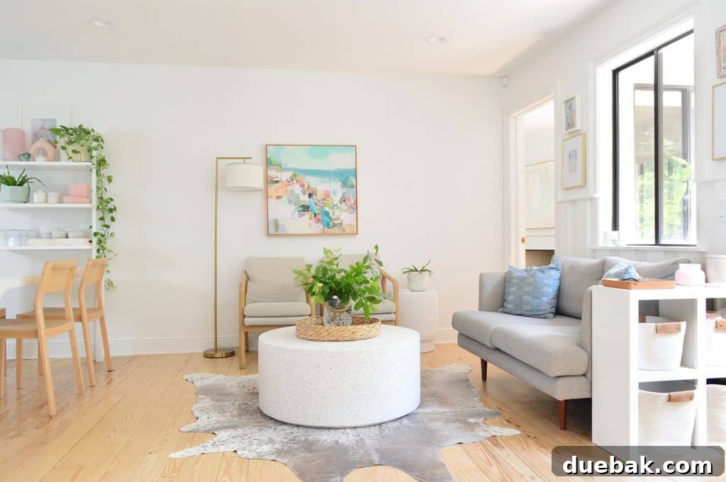 Inviting seating area with a round stone coffee table adjacent to the kitchen, promoting interaction.