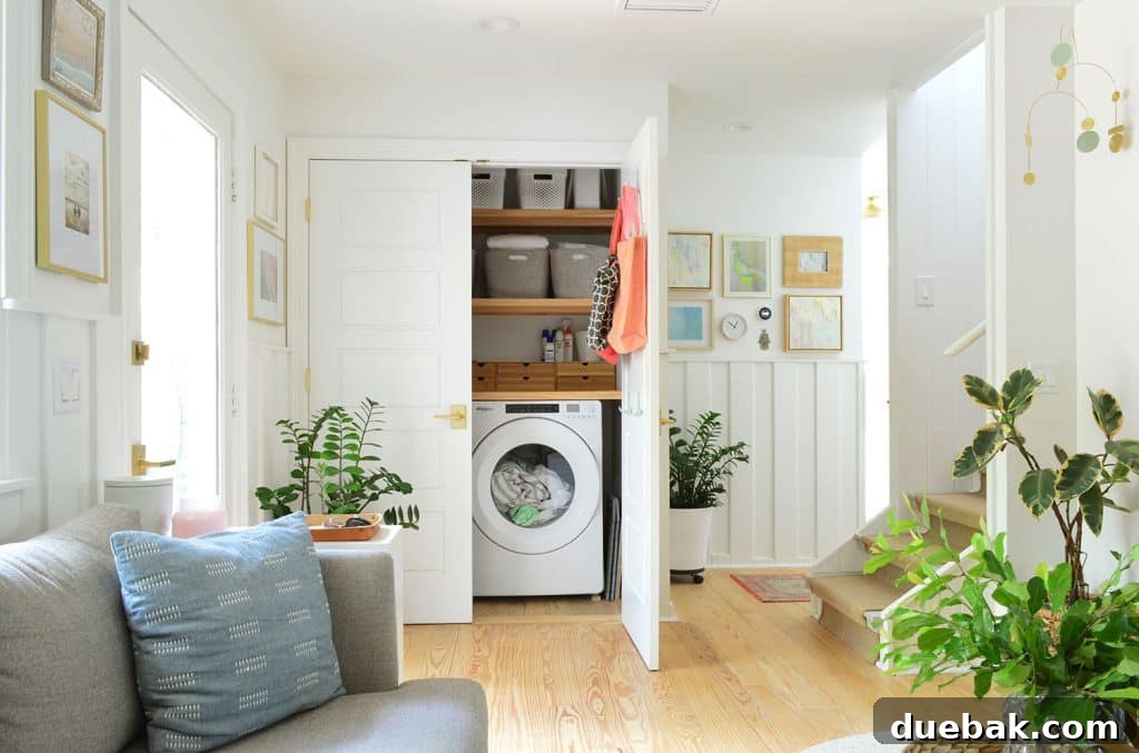 One door open in the laundry closet behind the seating area, revealing a glimpse of the appliances and storage.