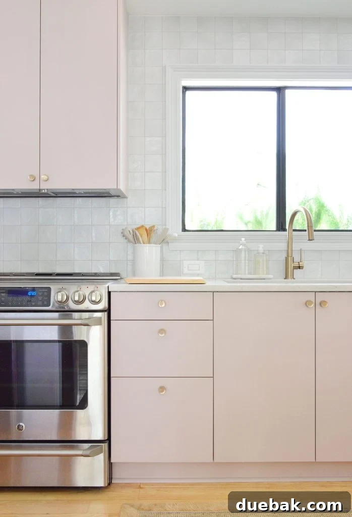 Vertical View Of Mauve Pink Painted Ikea Kitchen Cabinets With Gray Tile Backsplash