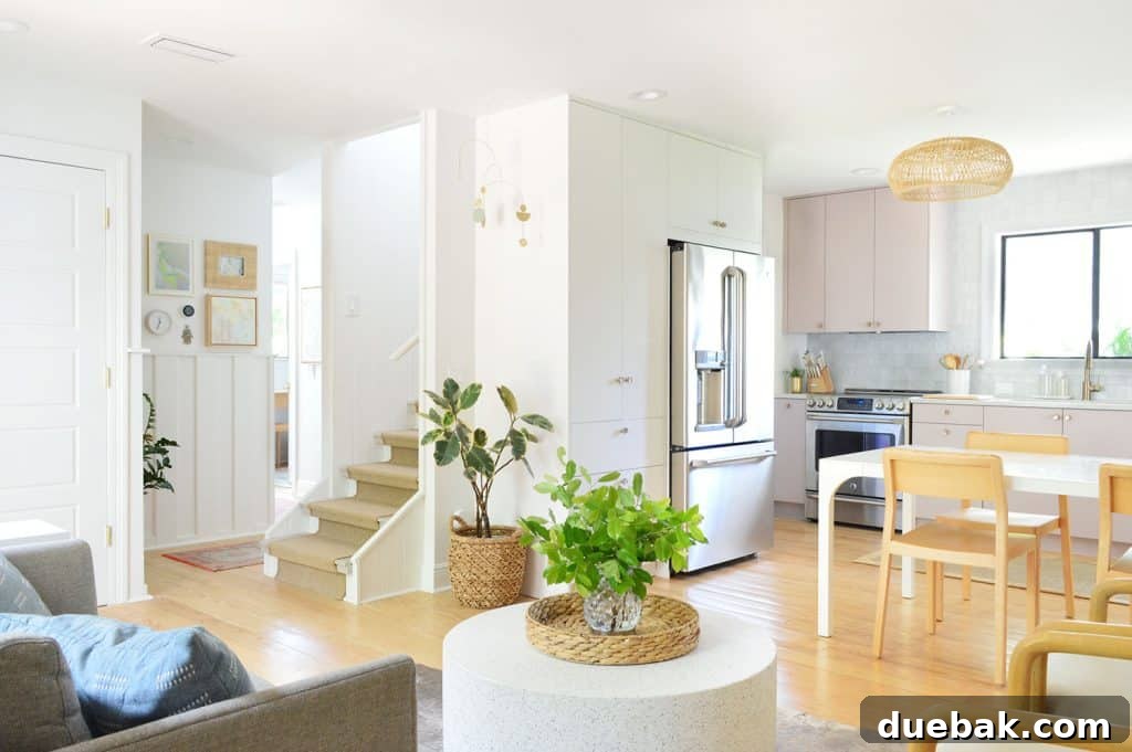 Wide View Of Beachy Mauve Kitchen and Seating Area With Stairs