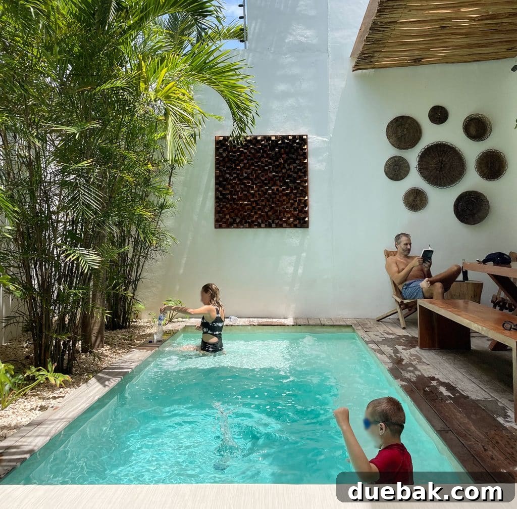 Kids Playing John Reading At Airbnb Pool In Tulum Mexico