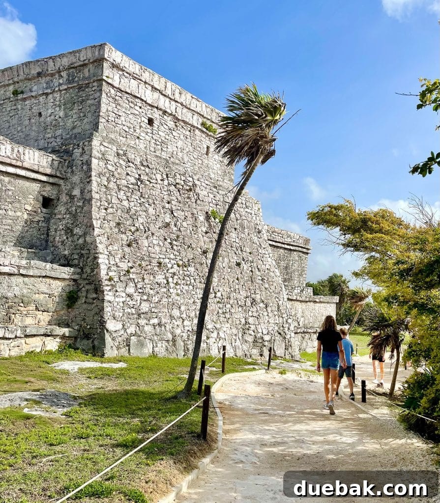 Kids Walking In Front of Castillo At Tulum Ruins Mexico
