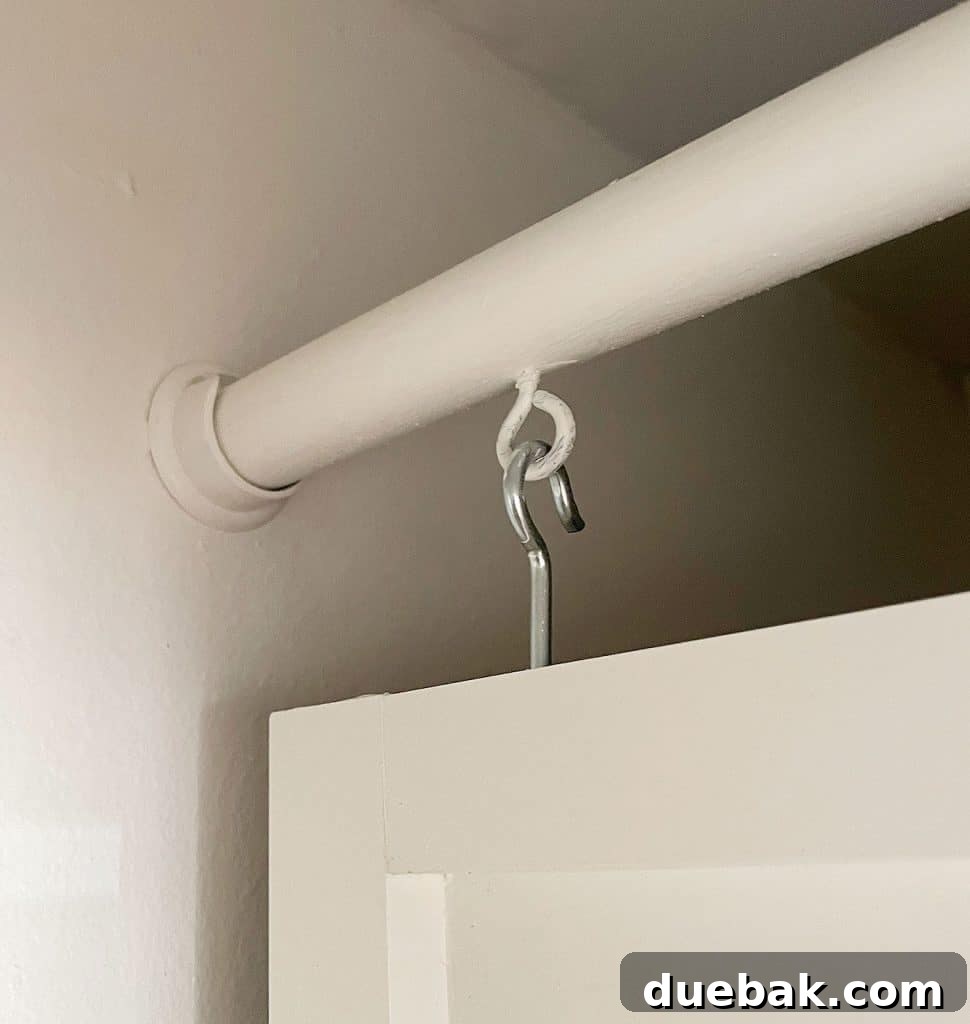 Maximizing Your Utility Closet Space 27 Eye Hook Suspending Wood Panel From Closet Rod In Utility Closet
