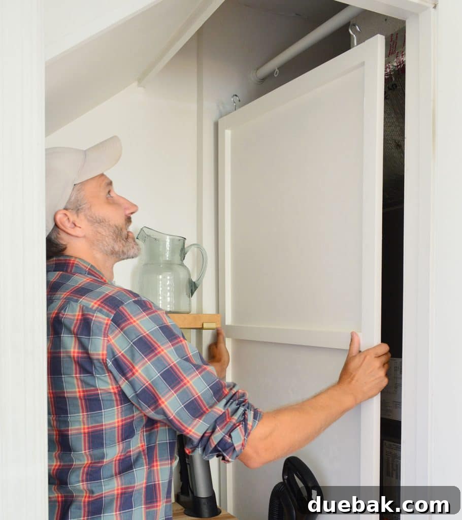 Maximizing Your Utility Closet Space 36 John Lifting HVAC Cover Panel Off Of Hanging Rod