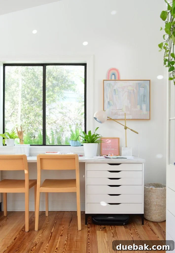 Kids art desk made from Ikea dressers and laminate marble countertop with wood chairs