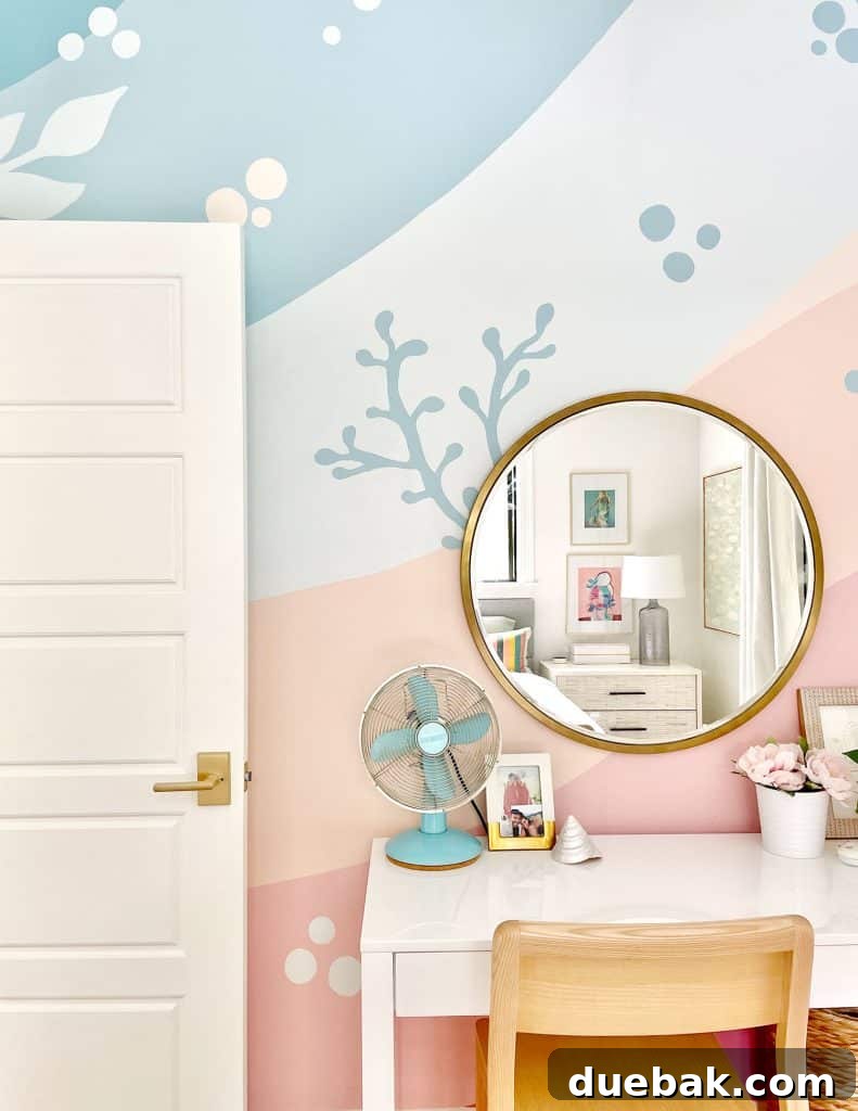 Colorful Girls Bedroom With Blue Pink Coral Beachy Mural With Gold Mirror Over Desk