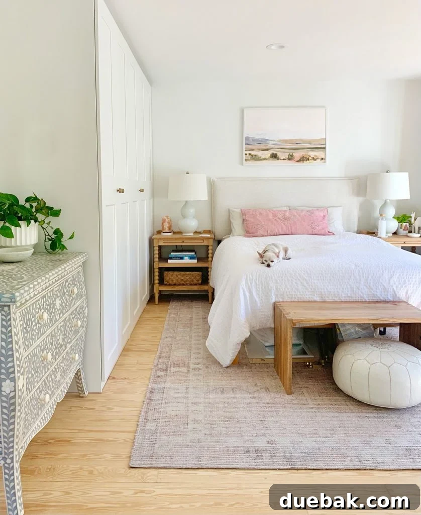 White beachy bedroom with ikea pax wardrobe closets along one wall