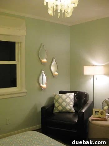 Three ZGallerie mirrored sconces artfully arranged on a bedroom wall