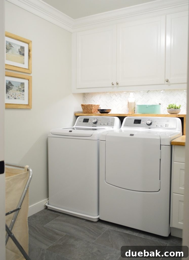 White Laundry Room With Marble Tile Backsplash