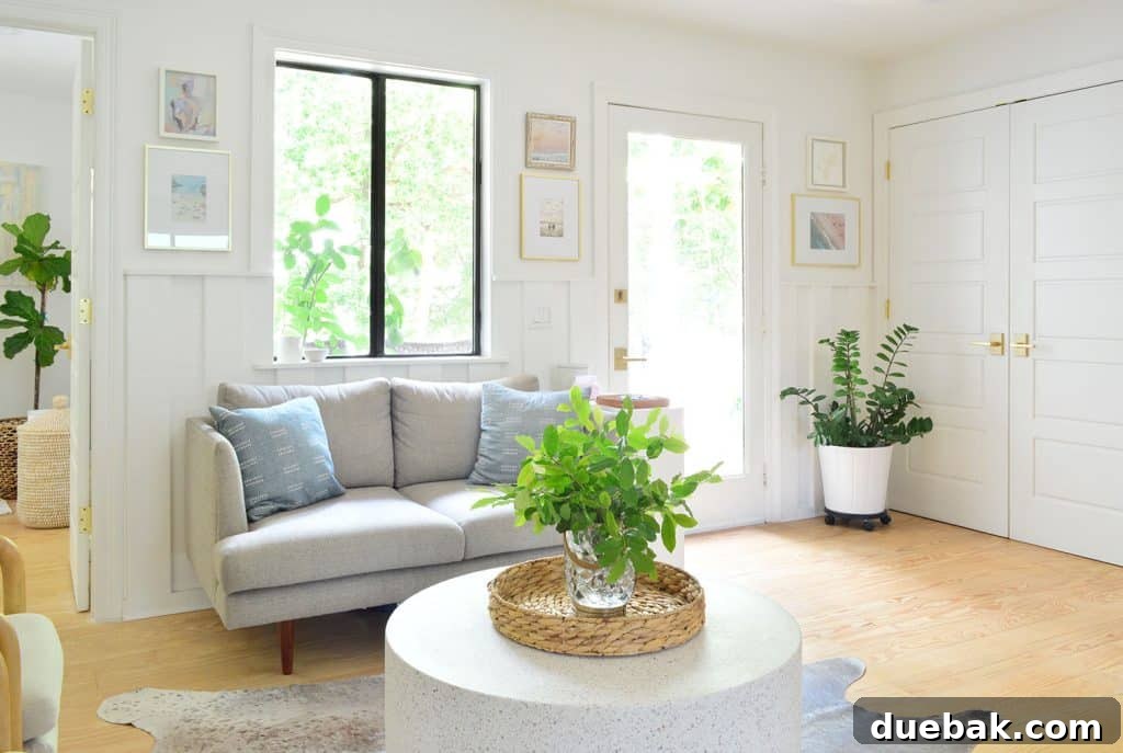View Of Seating Area And Front Door With Laundry Closet In Background