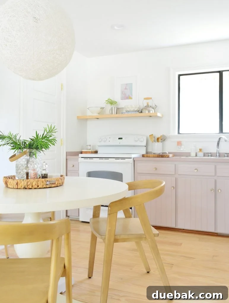 Upgrade Your Old Cabinets with Invisible Hinges 2 Simple white kitchen with mauve Artsy Pink cabinets and pedestal table