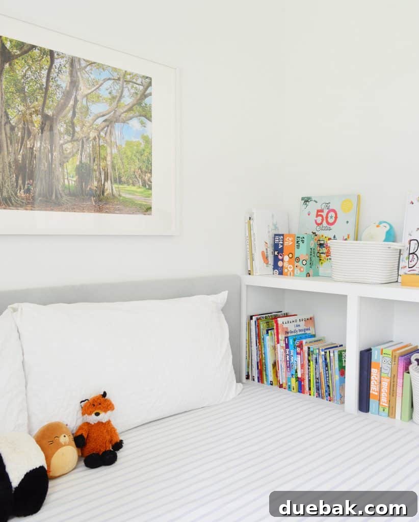 Boy's bedroom featuring a DIY fabric upholstered headboard and a custom built-in bookcase footboard, highlighting the cohesive and incredibly budget-friendly design achieved through DIY efforts.