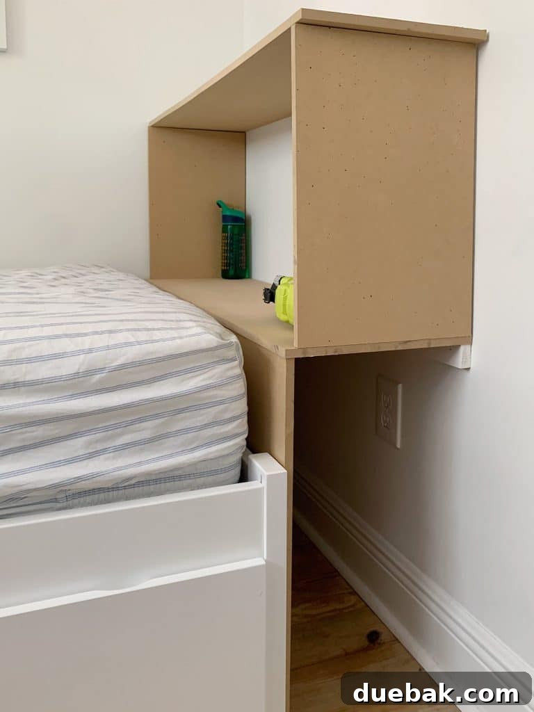The initial MDF framework of the built-in bookcase under construction in the boy's bedroom, demonstrating the precise dry-fitting of components before permanent assembly.