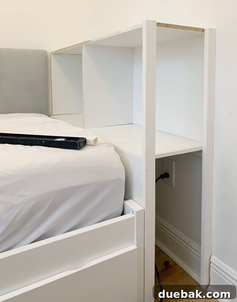 Side posts being carefully attached to the built-in bookcase in the boy's bedroom, showcasing the open shelf design facing the door for easy accessibility and an integrated look.