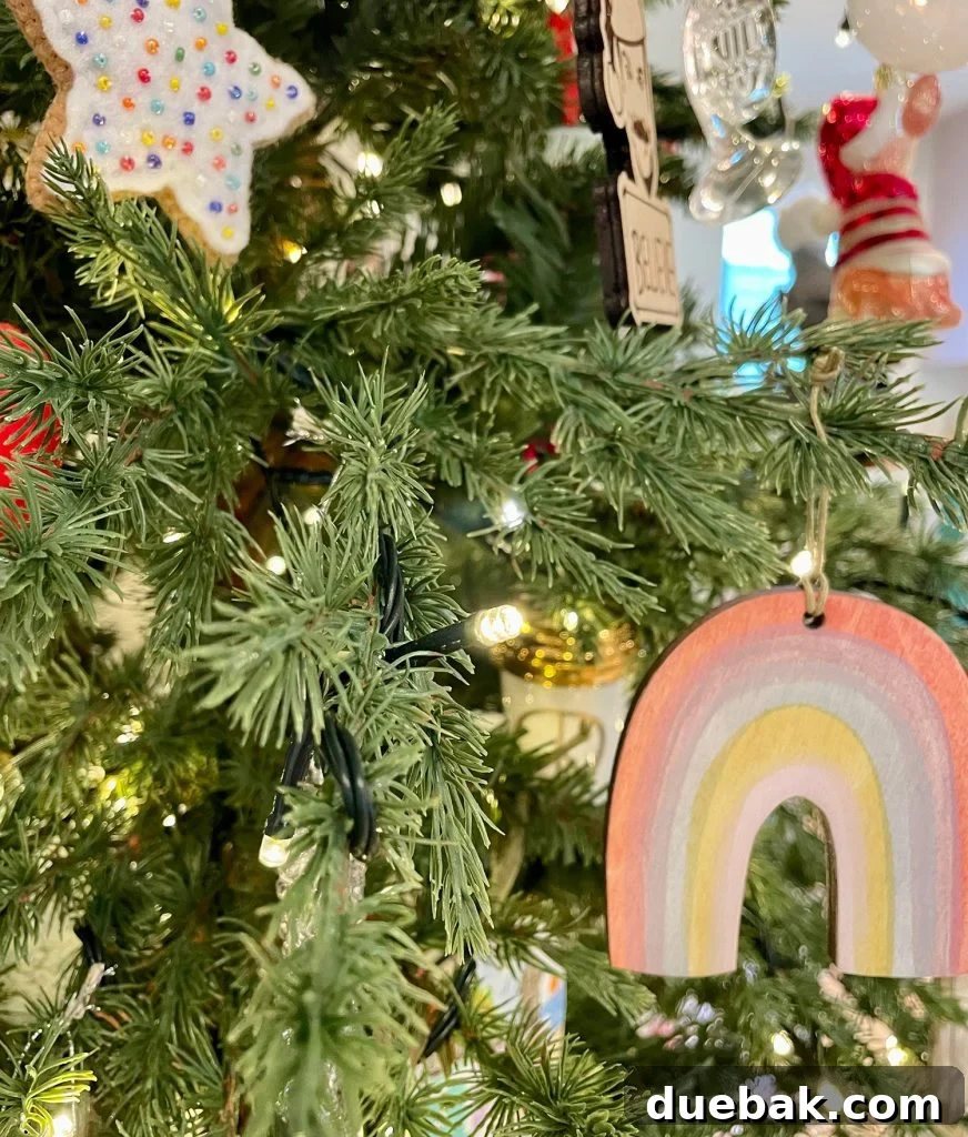 Close-up photo of warm white LED Christmas tree lights adorning a faux tree, highlighting their soft glow and intricate detail.