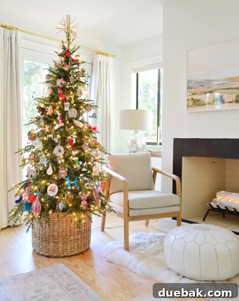 Slim Artificial Christmas Tree in a Woven Basket, positioned next to a modern chair and fireplace, exuding minimalist holiday charm.