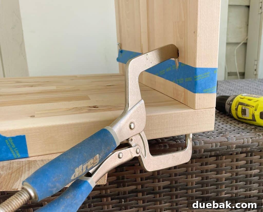 Elevate Your Bedroom with DIY Modern Nightstands 11 Kreg Pocket Hole Clamp Holding Butcher Block Nightstands Together During Initial Construction