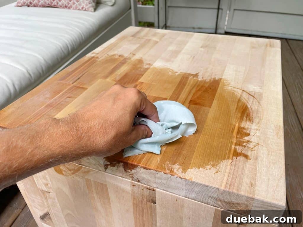 Elevate Your Bedroom with DIY Modern Nightstands 18 Applying Cutting Board Oil To Seal Butcher Block Bedside Table, Enhancing Grain