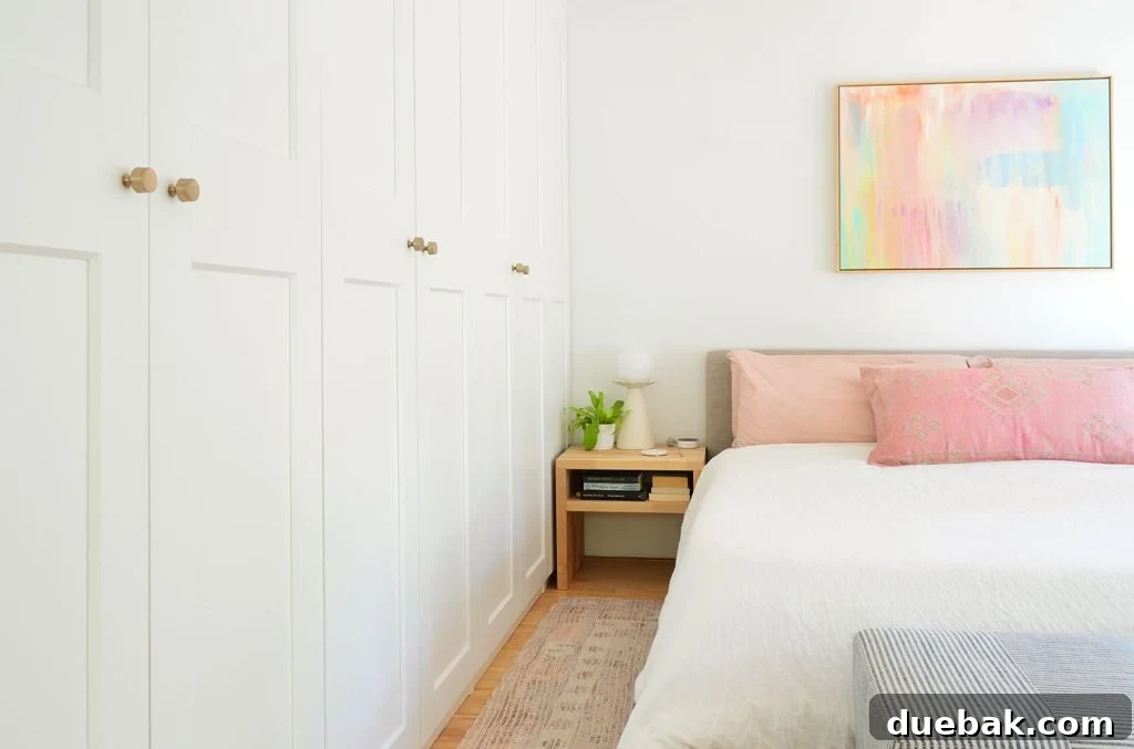 Wall Of Ikea Pax Wardrobes Next to King Size Bed With Colorful Painting