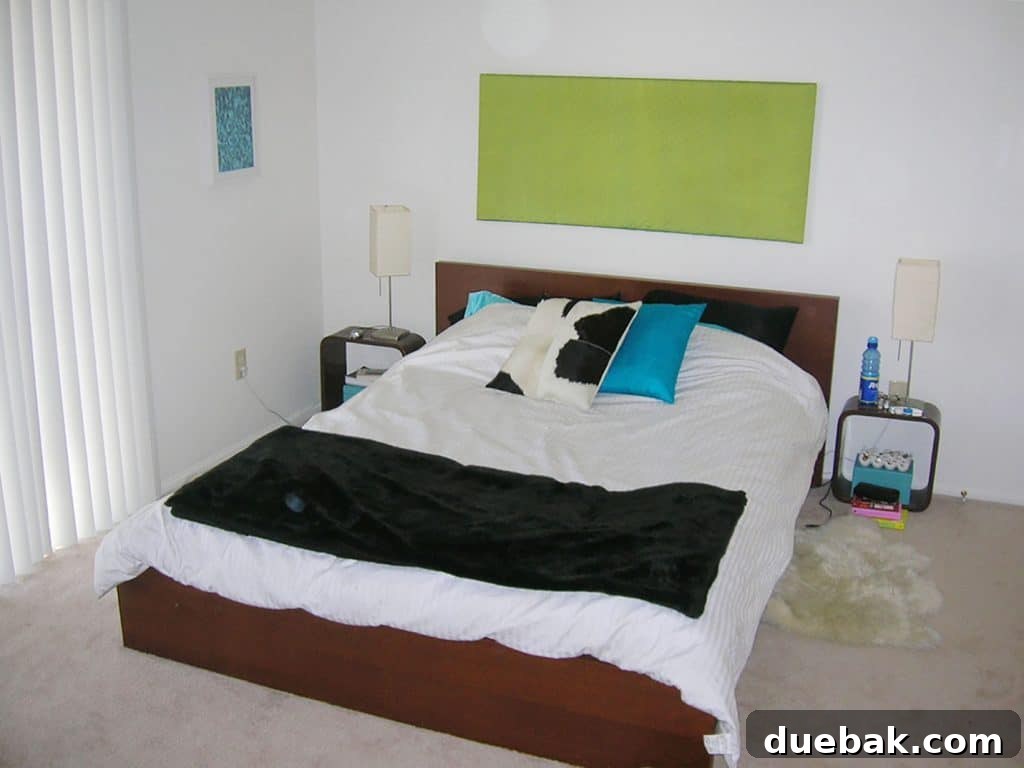 Old Apartment with Messy Queen Size Bed And Bold Color Accents