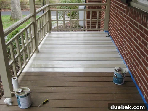 Progress shot of porch painting, showing first stripes being applied