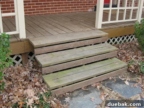 Bare front steps before painting, showing natural wood