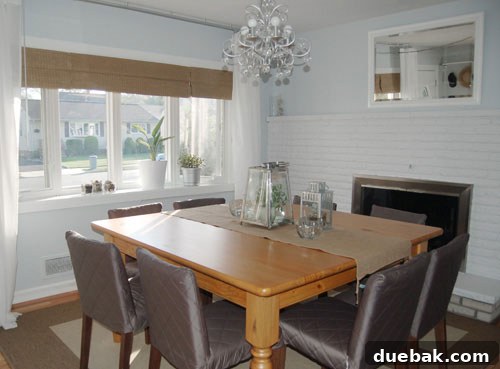 Glamorous dining room after makeover with new paint, elegant curtains, and refined decor, featuring a striking fireplace.