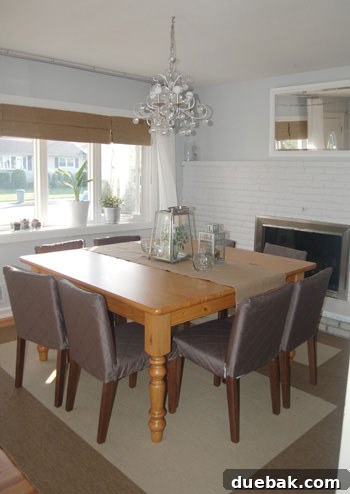 Luxurious dining room after transformation, close-up of beautifully styled fireplace and dining table with new runner and accessories.