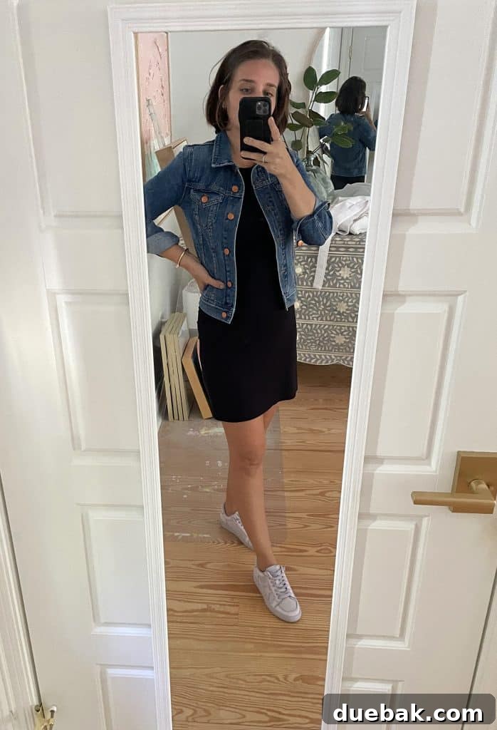 Parisian Chic Packing Secrets 16 Sherry selfie in mirror at home with short black dress and jean jacket and tennis shoes