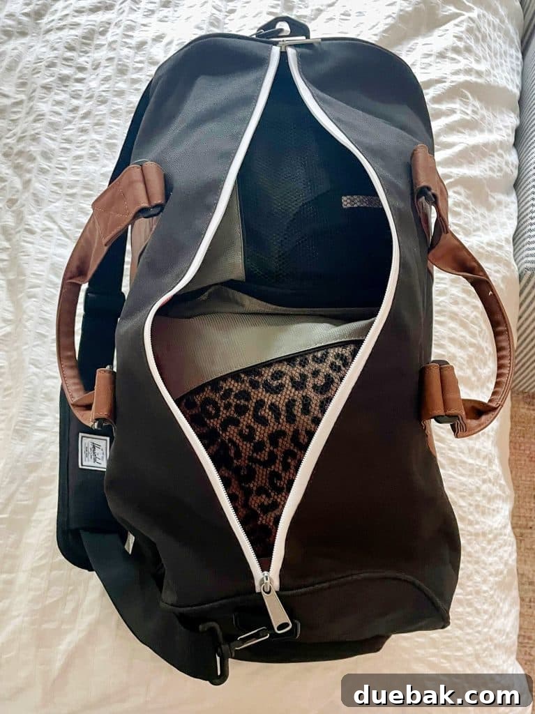 Parisian Chic Packing Secrets 3 Overnight duffel bag packed with packing cubes on bed