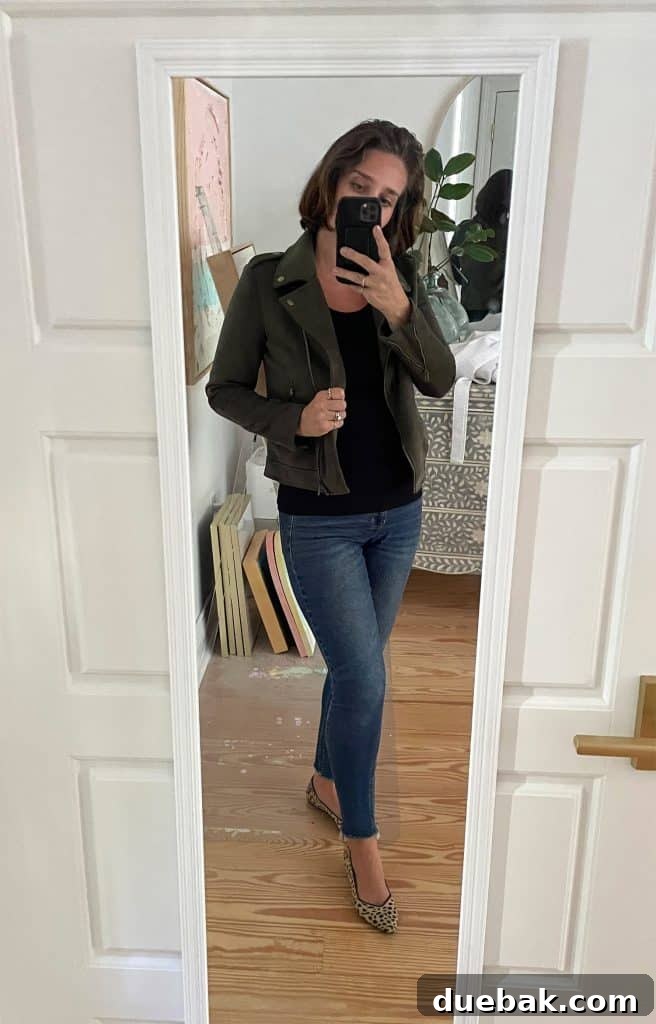 Parisian Chic Packing Secrets 21 Sherry selfie in mirror at home with black tank top with green jacket with leopard print flats