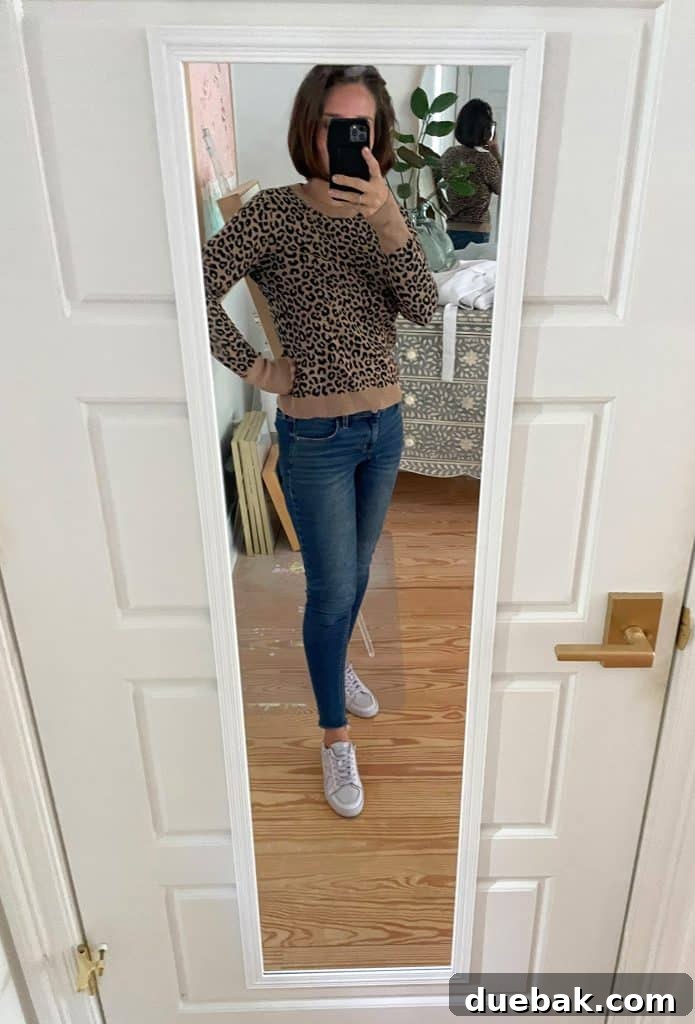 Parisian Chic Packing Secrets 31 Sherry selfie in mirror at home with leopard sweater and jeans