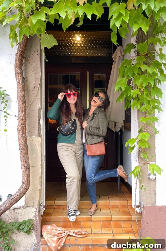 Parisian Chic Packing Secrets 34 Sherry and Elsie Larson posing in a doorway with green jacket over white tank