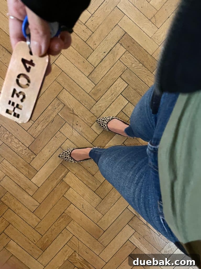 Parisian Chic Packing Secrets 35 Shot from above at jeans and leopard flats on herringbone wood floor