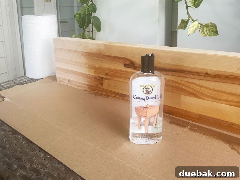 Butcher block counter being coated with cutting board oil sealant