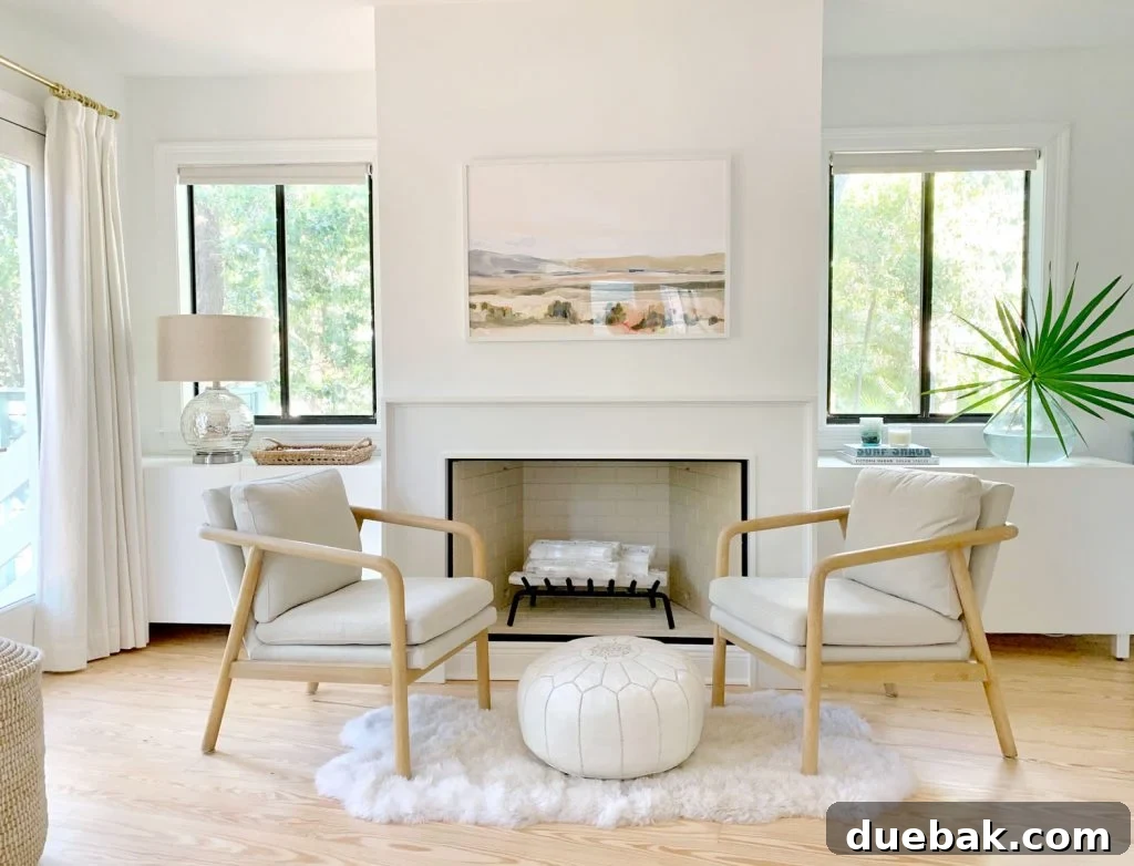Bedroom fireplace view with two chairs and Ikea Besta cabinets sitting on either side of fireplace
