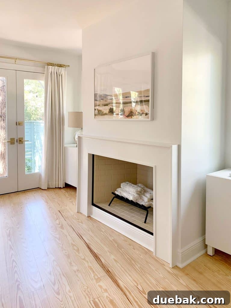 White modern fireplace with Ikea Besta storage cabinets sitting on either side