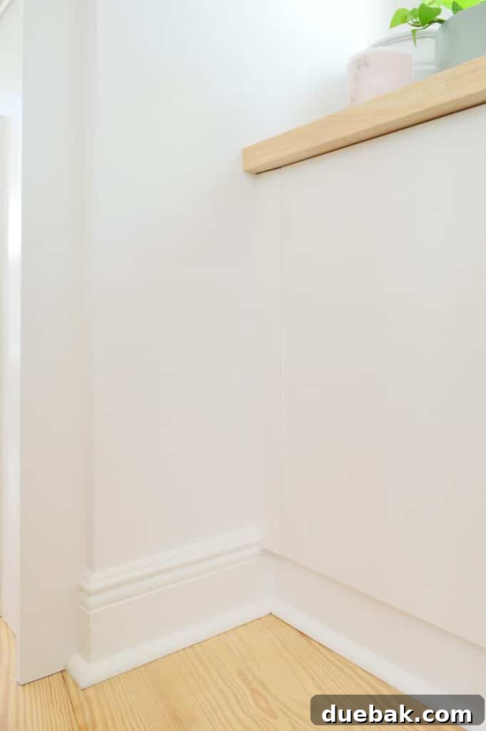Close up detail of trim added to side of Ikea Besta cabinets to look flush with doors