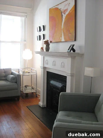 Open House Roulette 2 Vibrant tangerine abstract art above fireplace in modern minimalist living room