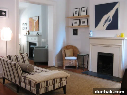 Open House Roulette 3 Bold square abstract art above fireplace in central living room with striped chaise