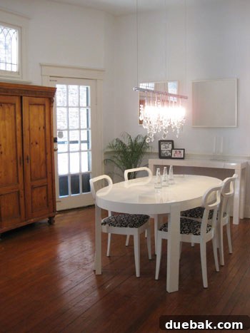 Open House Roulette 4 Elegant linear chandelier illuminating a minimalist dining room