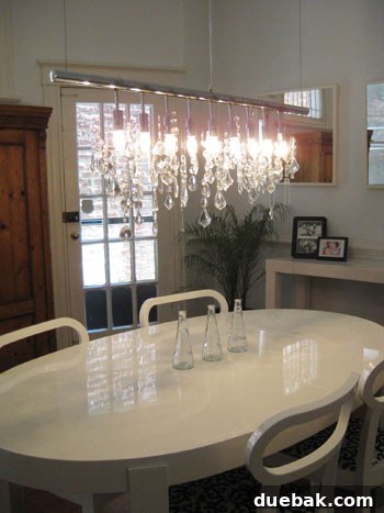 Open House Roulette 5 Close-up detail of a modern linear chandelier in a dining room