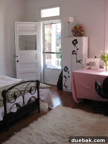Open House Roulette 7 Guest bedroom with iron bed, IKEA cabinet with decals, and fabric-draped table