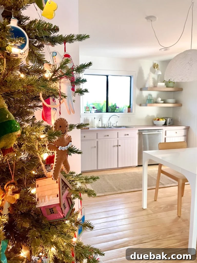 Joyful Simplicity: Our Holiday Edit 2 Minimalist Christmas tree near pantry in a modern kitchen